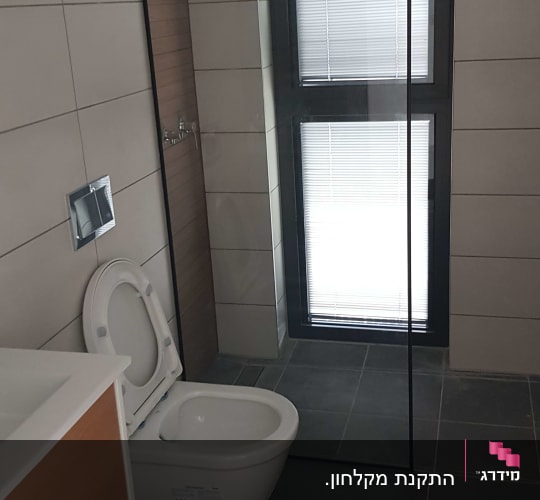 מקלחת עם ראש גשם ודלת זכוכית